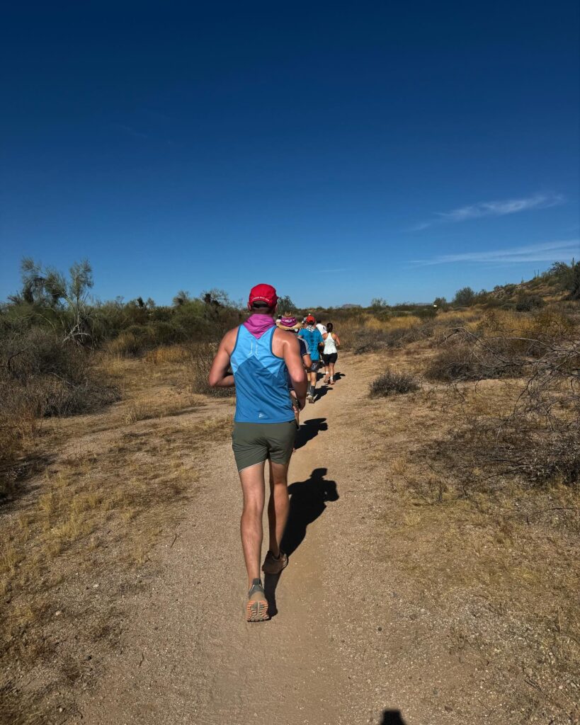distance running group on the trail in the dessert
