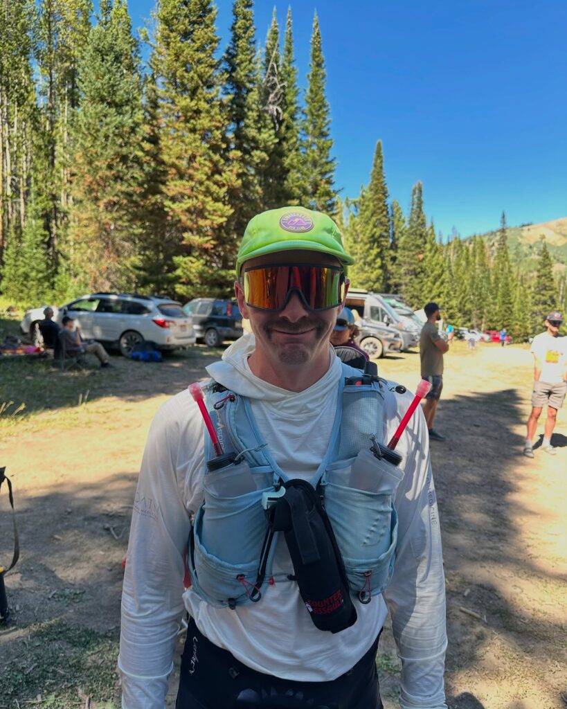 man with a mustache in the mountains after a distance trail run