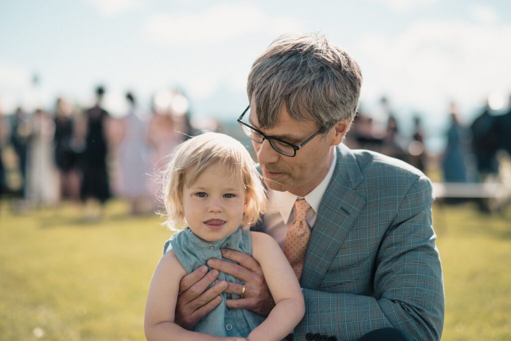 father and young daughter share a moment at cocktail hour at a romantic, western wedding in Jackson Hole